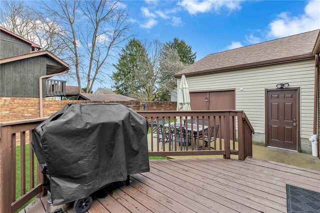 wooden deck with fence and area for grilling