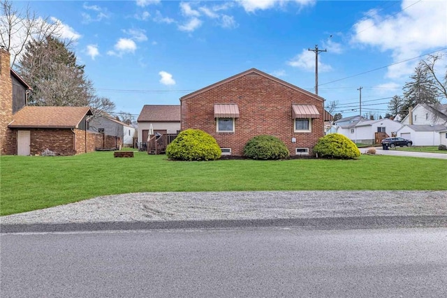 view of home's exterior featuring a yard and brick siding