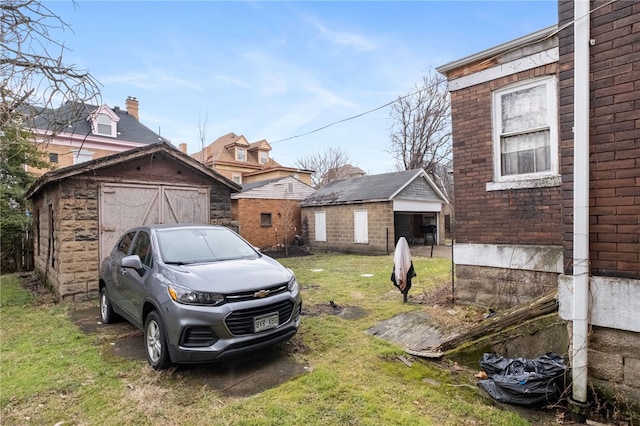 view of yard with an outdoor structure, a detached garage, and a shed