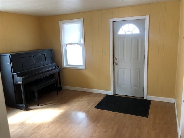 foyer entrance featuring baseboards and wood finished floors