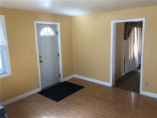 entrance foyer with baseboards and wood finished floors