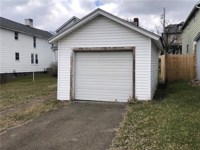 detached garage with fence and driveway