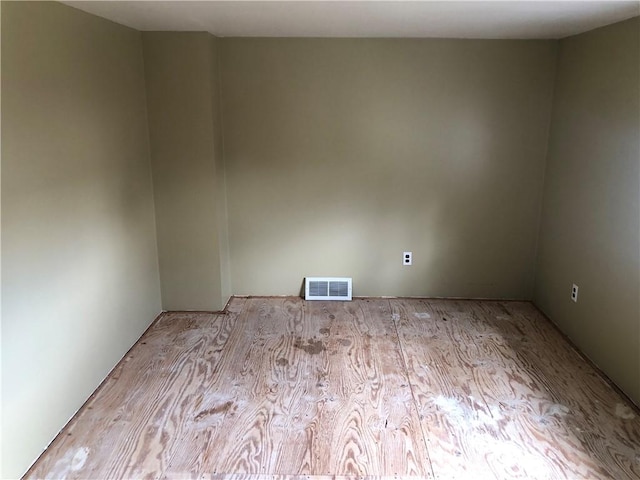 unfurnished room featuring visible vents