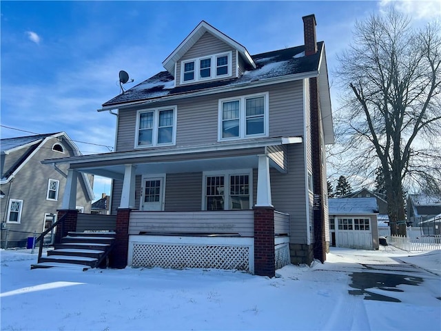 traditional style home with a garage, a chimney, and a porch