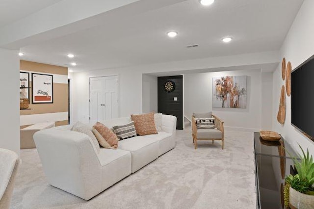 living room featuring recessed lighting, light colored carpet, and visible vents