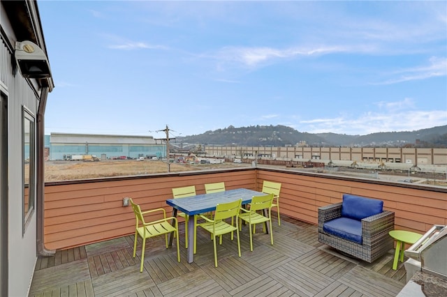 exterior space with a mountain view and outdoor dining area