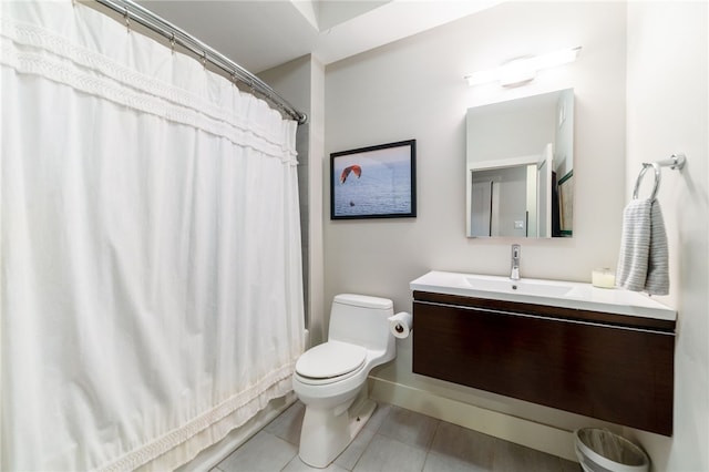 bathroom featuring toilet, vanity, a shower with shower curtain, and tile patterned floors