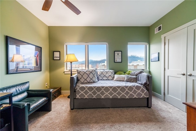 carpeted bedroom featuring a closet, visible vents, ceiling fan, and baseboards