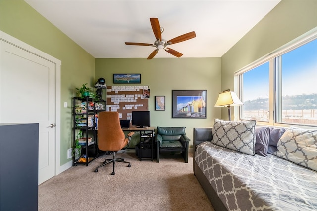 carpeted office space with ceiling fan