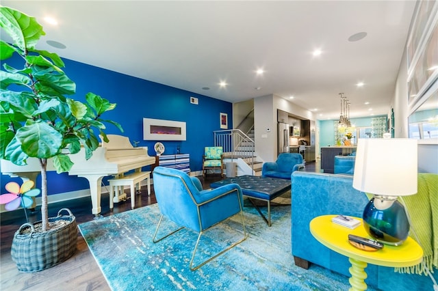 living area featuring stairway, wood finished floors, and recessed lighting