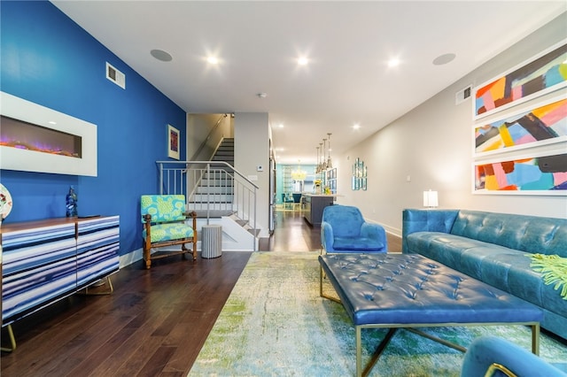 living room with stairway, visible vents, wood finished floors, and recessed lighting