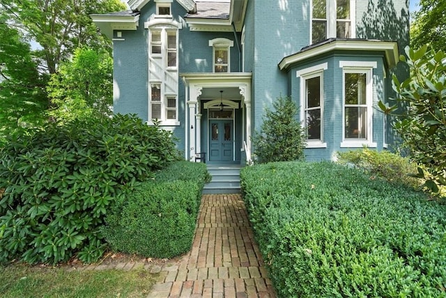 doorway to property featuring brick siding