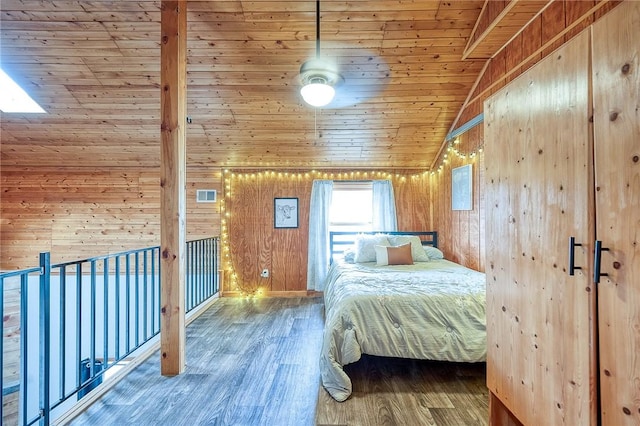 unfurnished bedroom featuring visible vents, wood ceiling, vaulted ceiling, wood walls, and wood finished floors