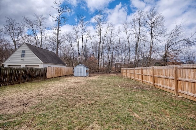 view of yard featuring a storage shed, a fenced backyard, and an outdoor structure