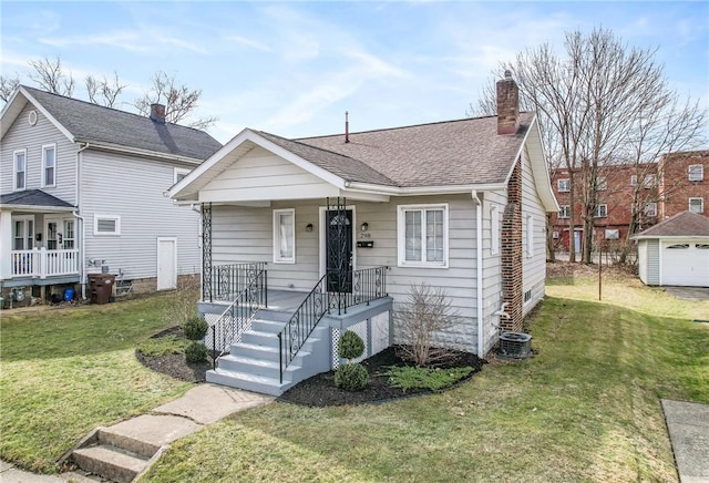 bungalow-style home featuring a shingled roof, covered porch, a chimney, and a front lawn