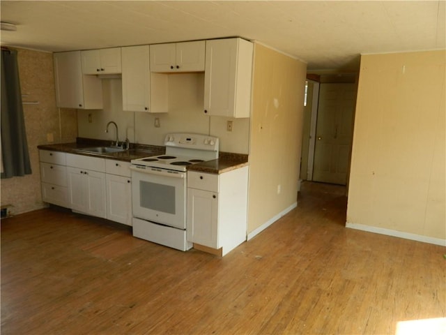 kitchen featuring light wood-style flooring, white electric stove, white cabinetry, and a sink