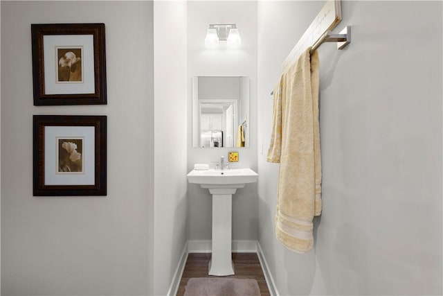 bathroom featuring wood finished floors and baseboards