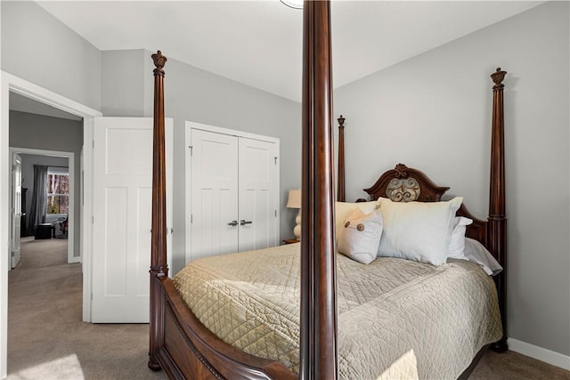 bedroom with carpet, a closet, and baseboards