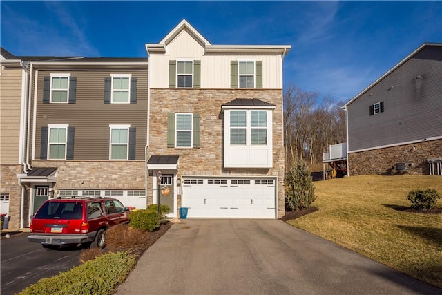 view of front facade featuring an attached garage, driveway, stone siding, board and batten siding, and a front yard