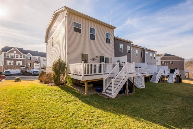 back of property with a deck, a yard, stairs, and a residential view