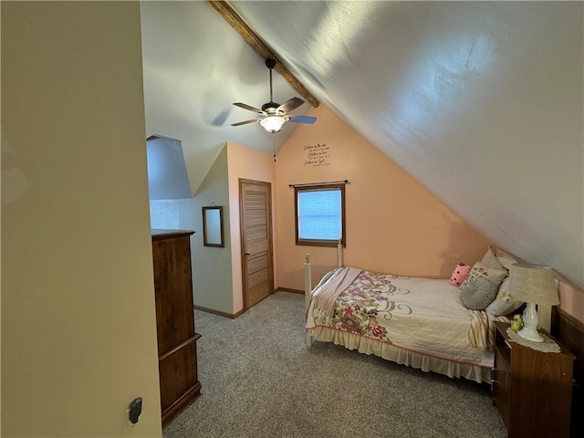 carpeted bedroom featuring a closet, vaulted ceiling with beams, baseboards, and a ceiling fan