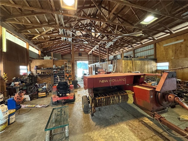 miscellaneous room with lofted ceiling and a workshop area