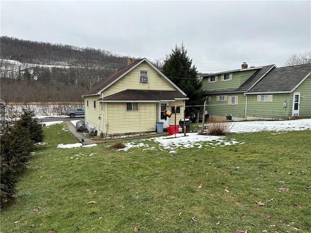 rear view of property with a yard