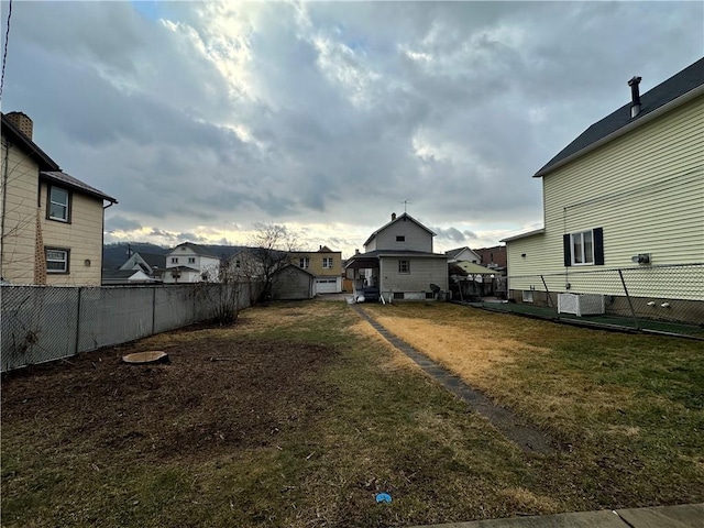 view of yard featuring a residential view and central AC unit