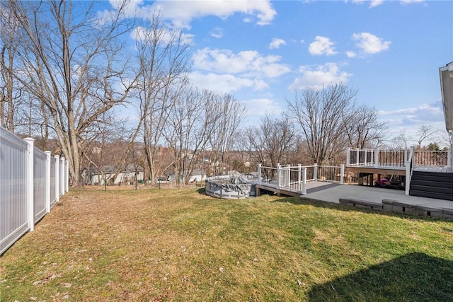 view of yard featuring a fenced backyard, a patio, and a deck