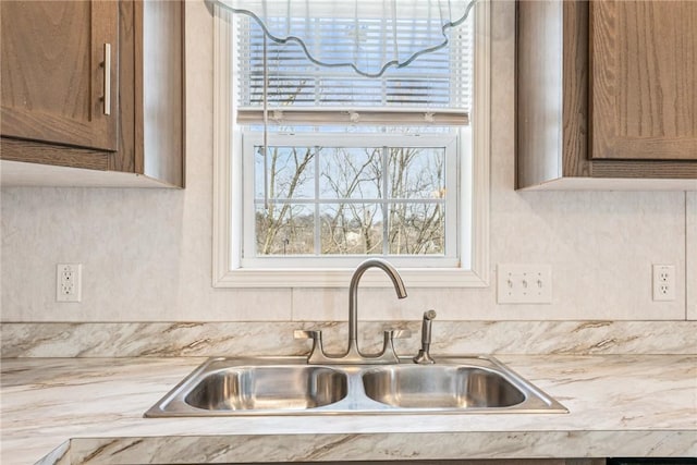 kitchen featuring light countertops and a sink