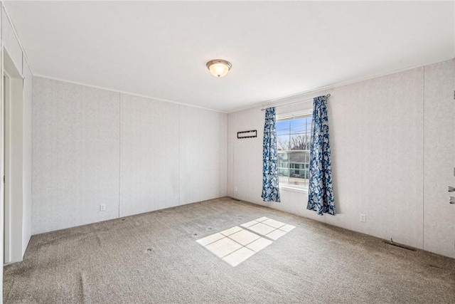 carpeted spare room with crown molding