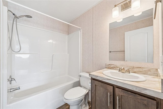 bathroom with bathing tub / shower combination, toilet, and vanity