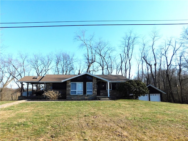 view of front facade with a garage, stone siding, and a front yard