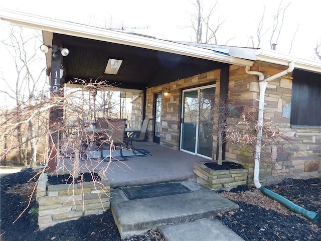 doorway to property with stone siding