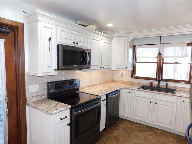 kitchen featuring electric stove, tasteful backsplash, stainless steel microwave, a sink, and dishwasher