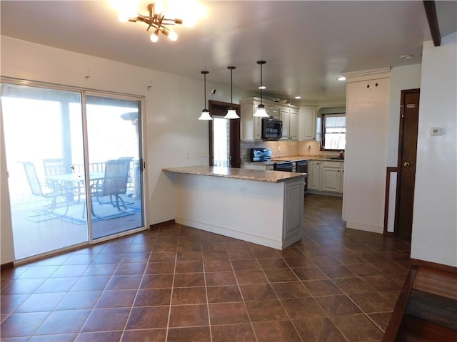 kitchen with decorative backsplash, light stone counters, a peninsula, stainless steel range with electric stovetop, and black microwave