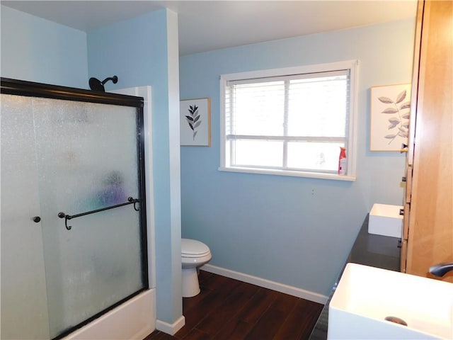 full bath featuring vanity, wood finished floors, toilet, and baseboards