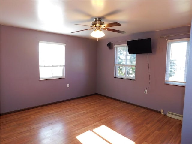 unfurnished room with a baseboard radiator, ceiling fan, light wood-style flooring, and baseboards