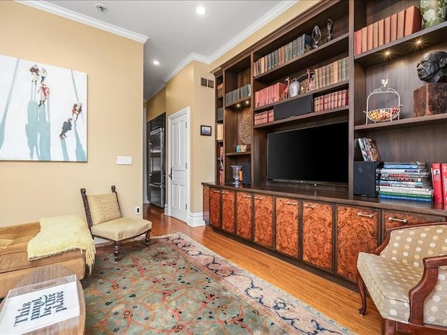 sitting room featuring crown molding, visible vents, wood finished floors, and recessed lighting