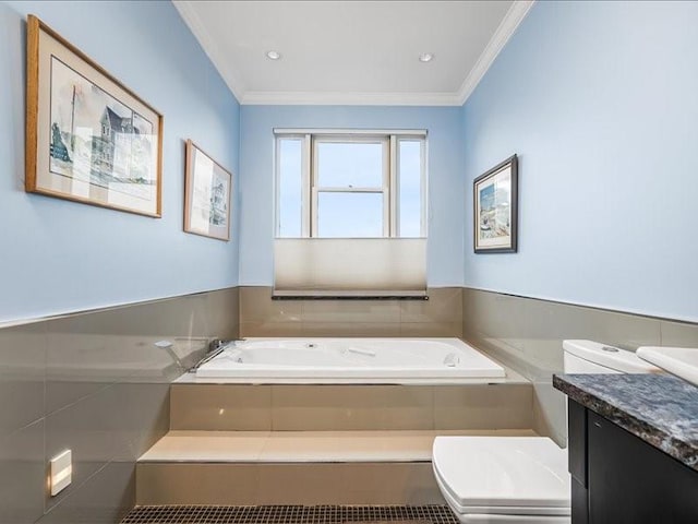 full bathroom featuring crown molding, vanity, toilet, and a bath