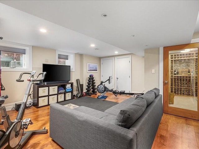 exercise area featuring recessed lighting and light wood-style floors