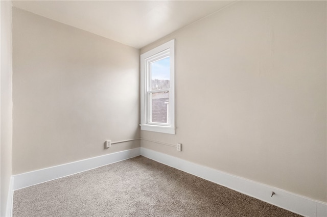 unfurnished room with baseboards and carpet flooring