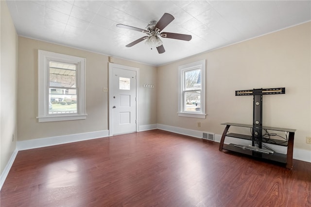 entryway featuring baseboards, visible vents, and wood finished floors