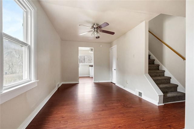 interior space with a wealth of natural light, visible vents, and wood finished floors