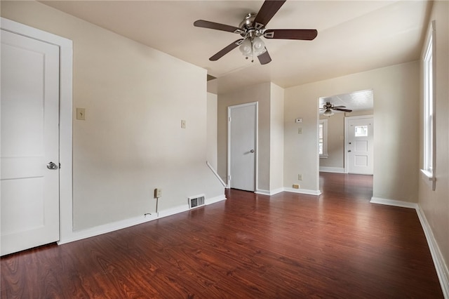 unfurnished room with visible vents, ceiling fan, baseboards, and wood finished floors