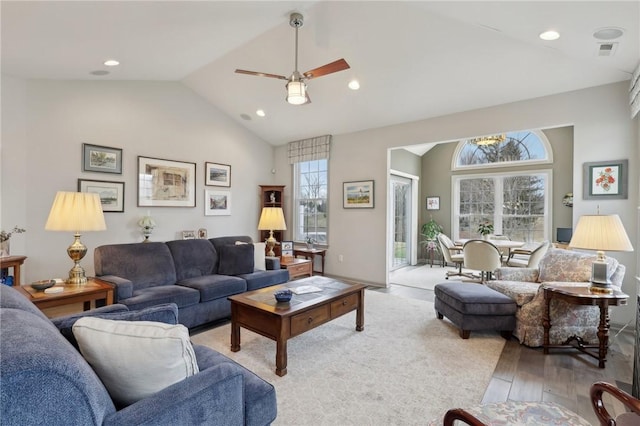 living room with lofted ceiling, wood finished floors, a healthy amount of sunlight, and recessed lighting