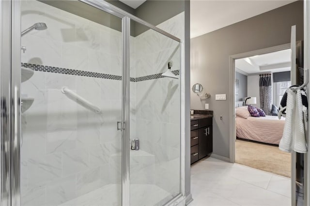 bathroom featuring connected bathroom, baseboards, a stall shower, vanity, and a raised ceiling