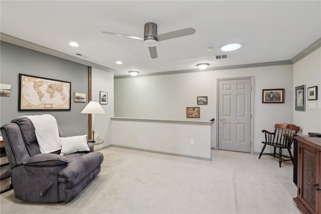 sitting room featuring visible vents, light colored carpet, crown molding, and baseboards