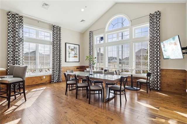 dining space with visible vents, plenty of natural light, hardwood / wood-style floors, and wainscoting