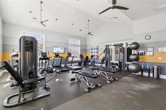 workout area featuring high vaulted ceiling, visible vents, baseboards, and ceiling fan